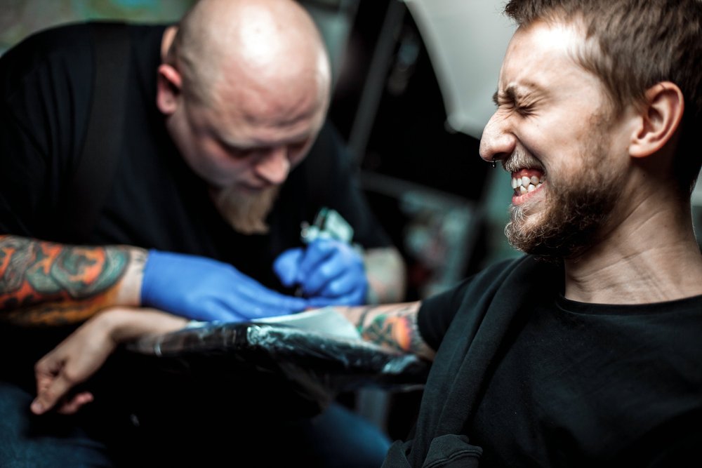 man in pain getting tat'd.jpg